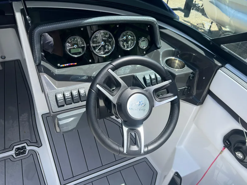Slide: The Image of 2021 Monterey M22 boat dashboard with steering wheel and instrument panel. - 5