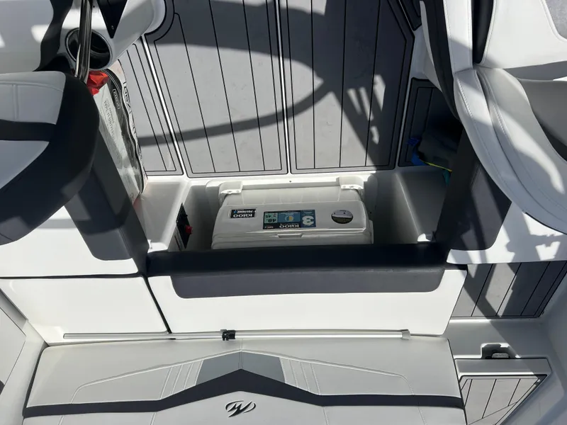 Slide: The Image of Interior of a 2021 Monterey M22 boat showing storage compartment and seating area. - 7