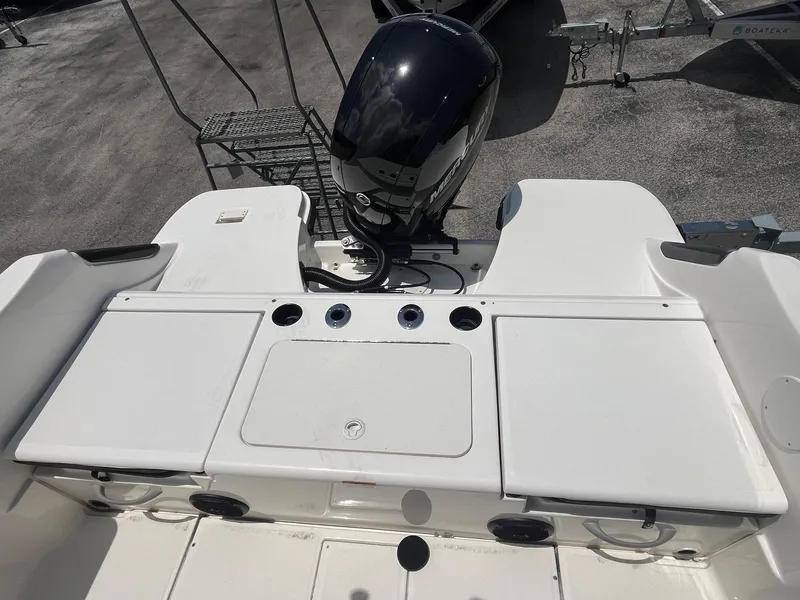 Slide: The Image of 2022 Bayliner Trophy T22CC boat with outboard motor and spacious deck layout. - 7