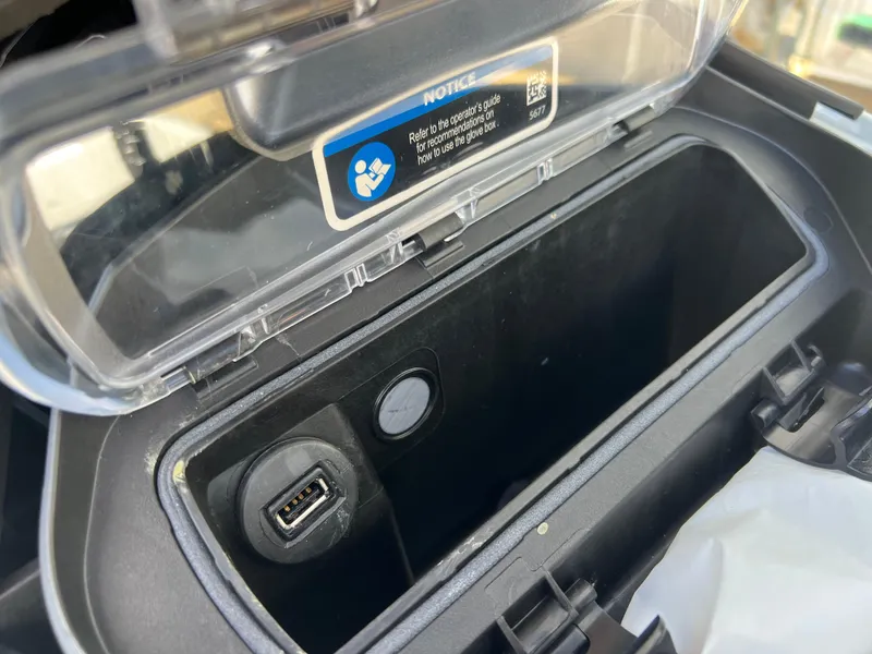 Slide: The Image of 2023 Sea-Doo GTX 300 glove box with USB port and storage compartment. - 7