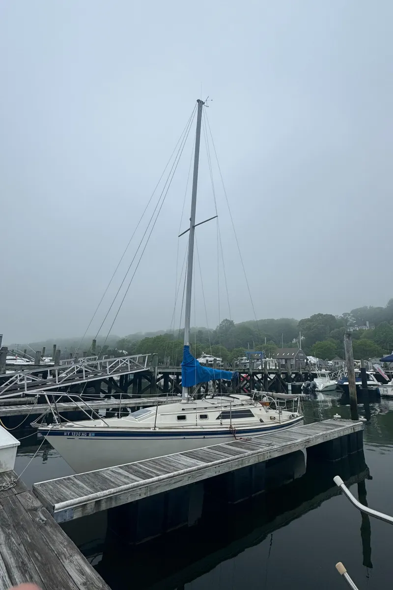 Slide: The Image of 1985 O'Day Sloop docked in a foggy marina setting. - 1