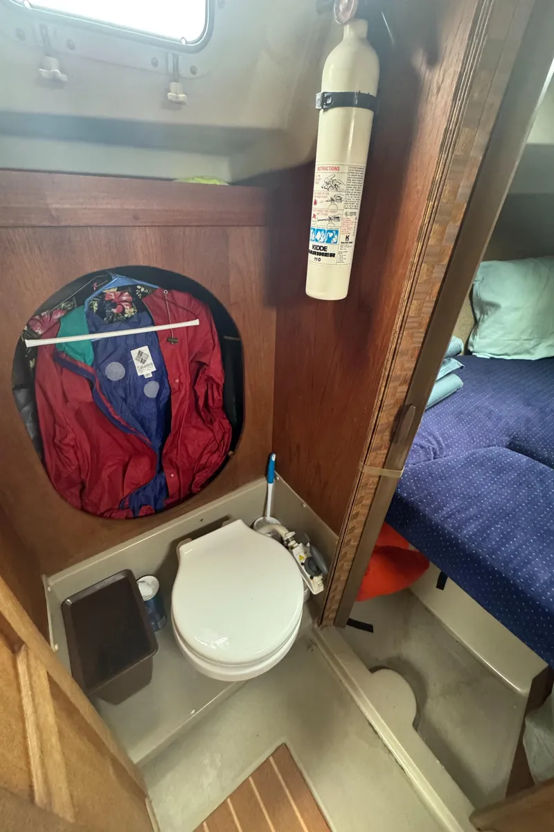 Slide: The Image of 1985 O'Day Sloop interior with compact bathroom and adjacent sleeping area. - 18