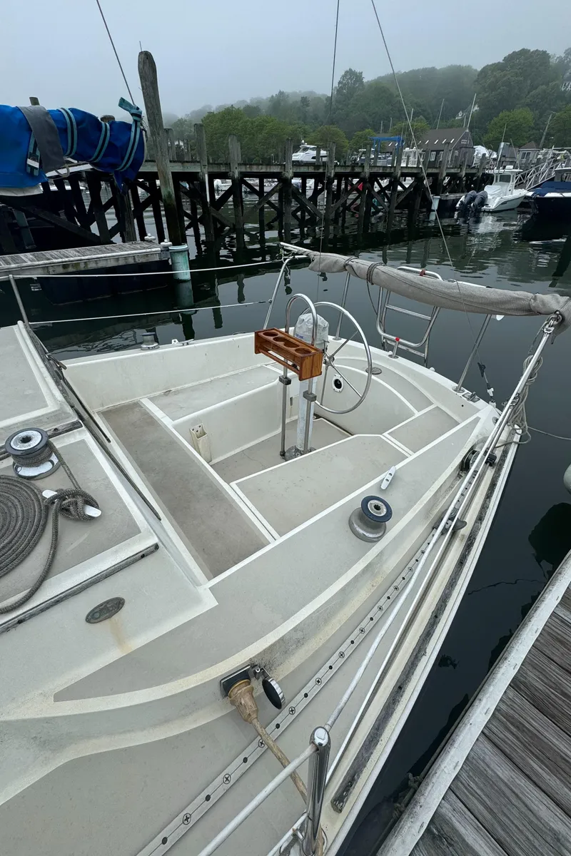Slide: The Image of 1985 O'Day Sloop sailboat docked at a marina on a foggy day. - 2
