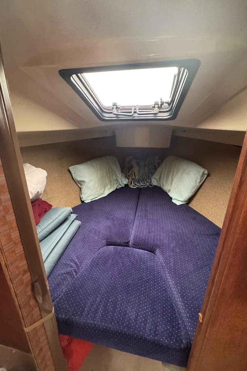 Slide: The Image of Interior cabin of a 1985 O'Day Sloop sailboat with cozy bedding. - 21