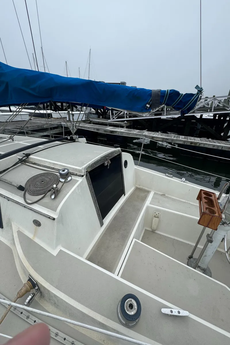 Slide: The Image of 1985 O'Day Sloop sailboat with blue sail cover, docked at marina. - 5