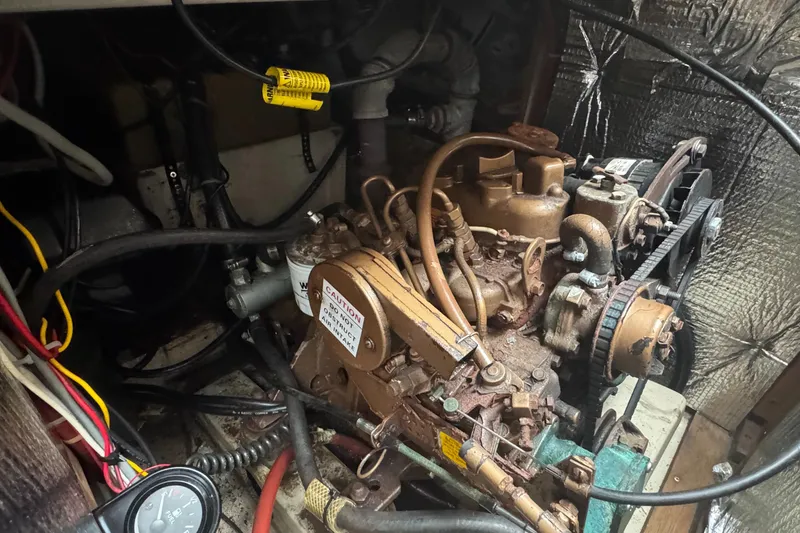 Slide: The Image of Engine compartment of a 1985 O'Day Sloop with visible mechanical components. - 6