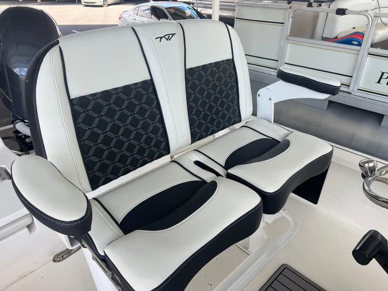 Slide: The Image of 2023 Tidewater 2110 boat seating with black and white upholstery, featuring armrests and stylish design. - 10