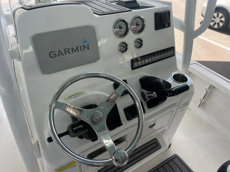Slide: The Image of 2023 Tidewater 2110 boat console with Garmin navigation, steering wheel, and control panel. - 11