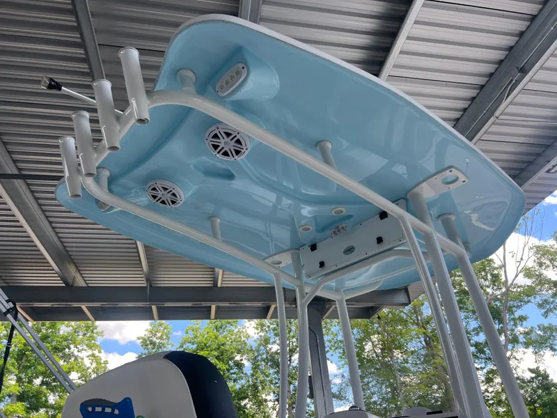 Slide: The Image of 2023 Tidewater 2110 boat T-top with rod holders and speakers under a metal roof. - 13