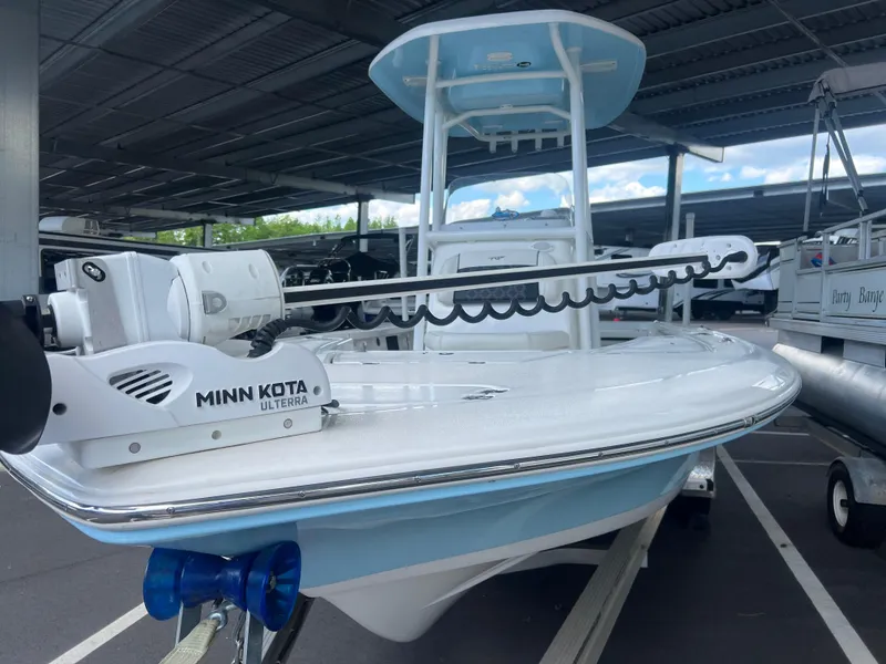 Slide: The Image of 2023 Tidewater 2110 boat with Minn Kota Ulterra motor, parked under a covered area. - 2