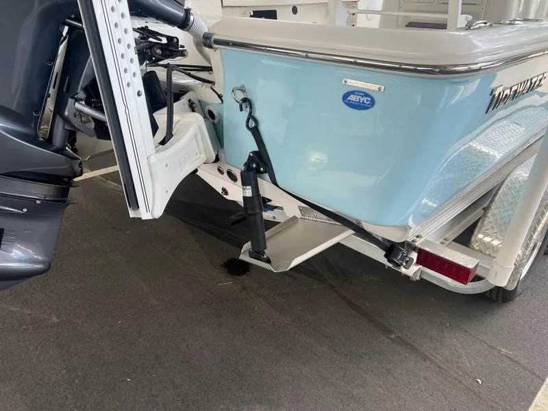 Slide: The Image of 2023 Tidewater 2110 boat rear view with motor and trailer details. - 4