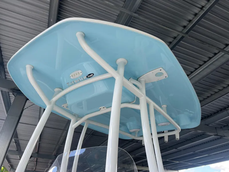 Slide: The Image of Tidewater 2110 boat T-top, 2023 model, featuring a light blue finish under a metal roof. - 5