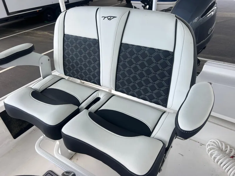 Slide: The Image of 2023 Tidewater 2110 boat seating with black and white cushioned design. - 9