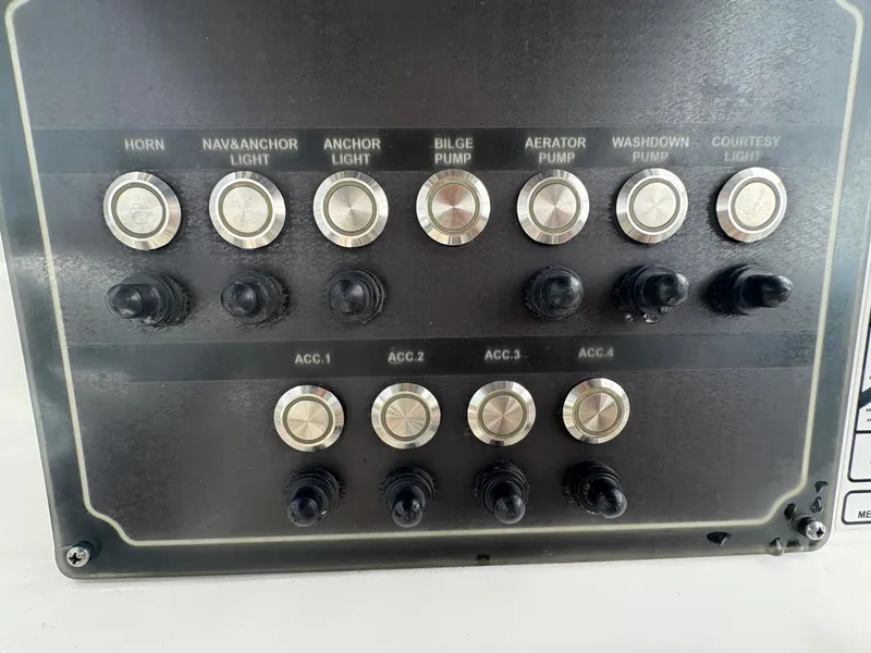 Slide: The Image of Control panel of a 2017 Sea Fox 206 Commander boat with labeled switches and buttons. - 15