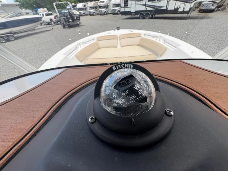 Slide: The Image of 2017 Sea Fox 206 Commander boat with Ritchie compass, docked near RVs and trailers. - 17