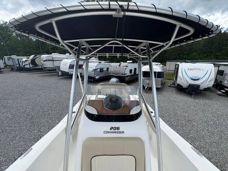 Slide: The Image of 2017 Sea Fox 206 Commander boat with T-top, parked among RVs in a gravel lot. - 18