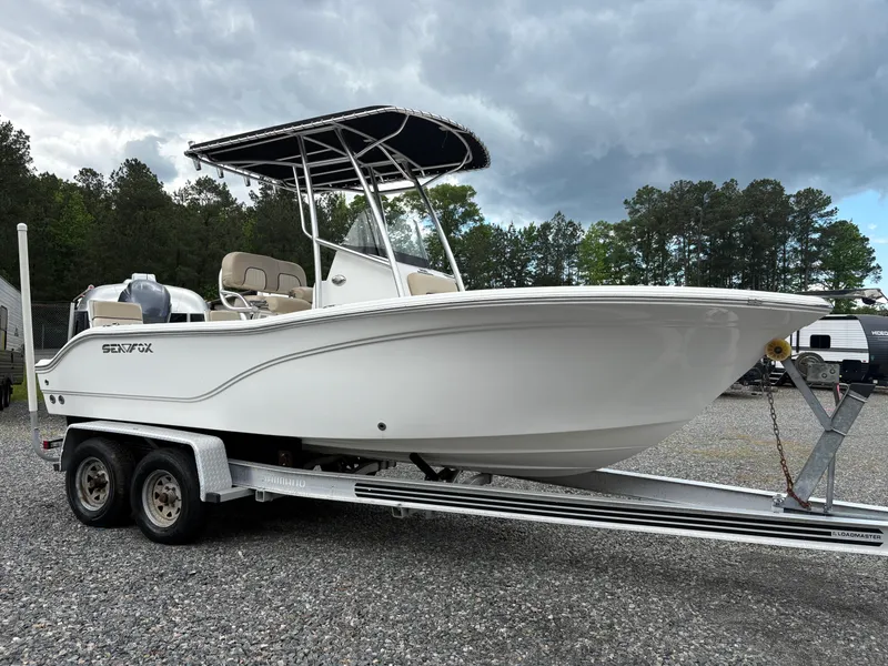Slide: The Image of 2017 Sea Fox 206 Commander boat on trailer, parked outdoors under cloudy sky. - 6