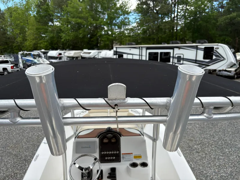 Slide: The Image of 2017 Sea Fox 206 Commander boat with rod holders and console, parked near RVs. - 9
