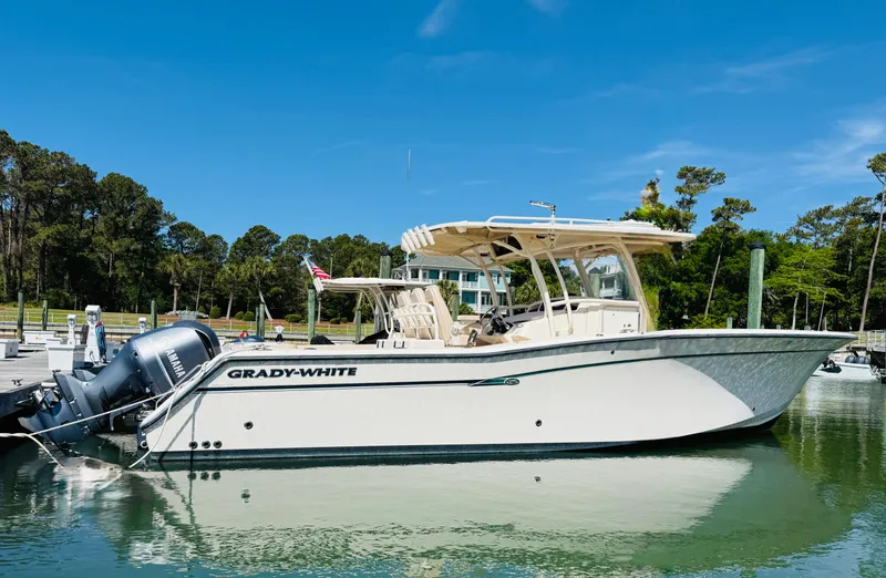 Slide: The Image of 2015 Grady-White 336 Canyon boat docked in a scenic marina setting. - 1
