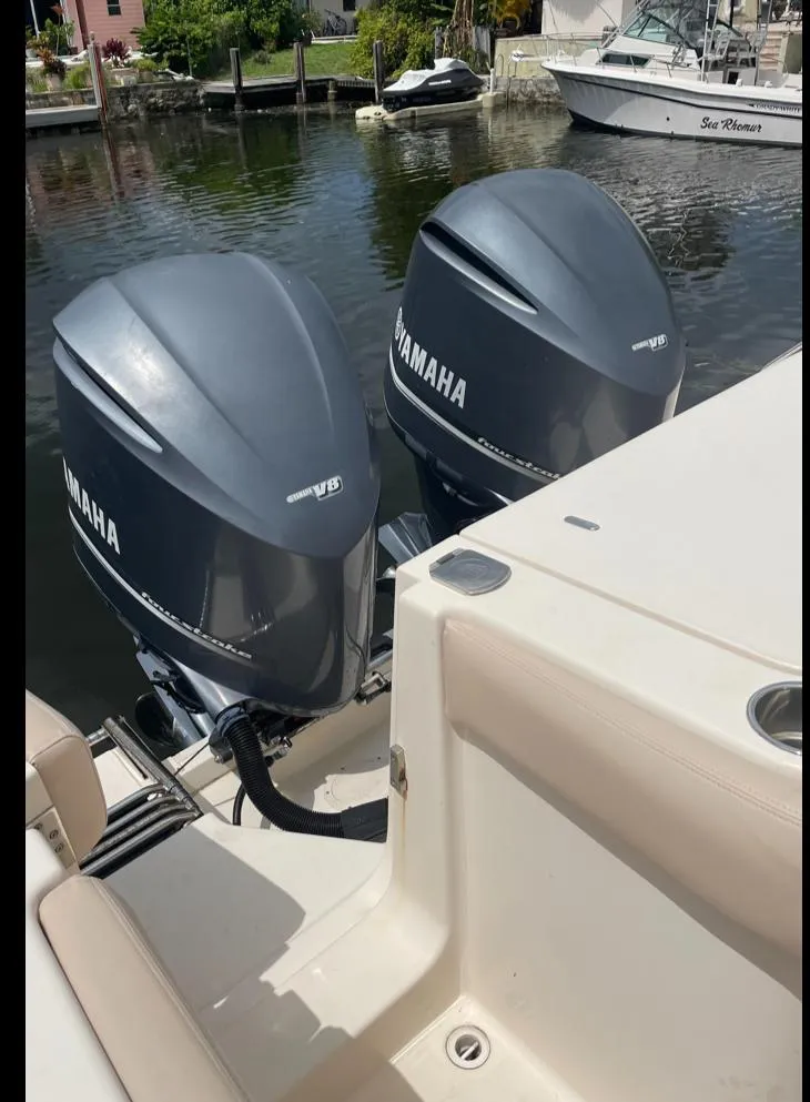 Slide: The Image of 2015 Grady-White 336 Canyon with twin Yamaha outboard engines docked by the water. - 17