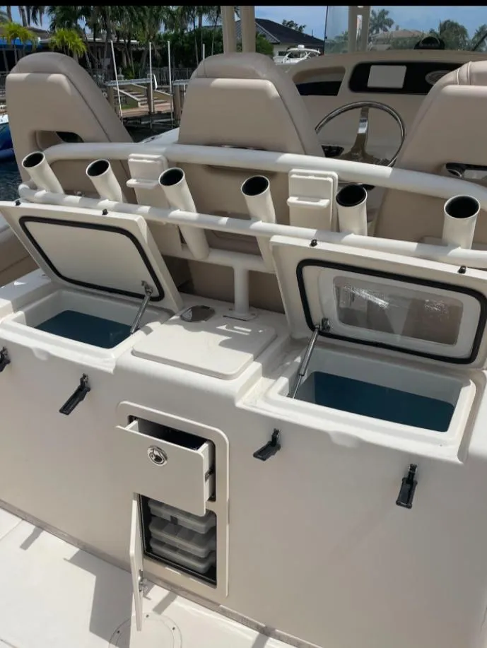 Slide: The Image of 2015 Grady-White 336 Canyon boat interior with storage compartments and rod holders. - 18