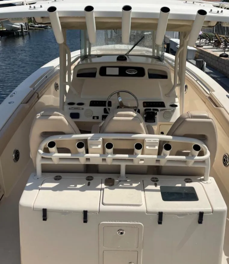 Slide: The Image of 2015 Grady-White 336 Canyon boat interior with helm and seating area. - 19