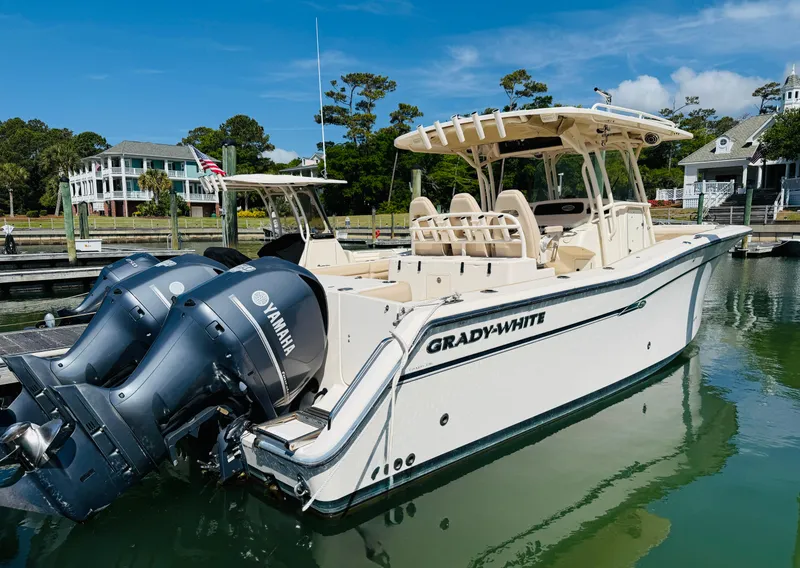 Slide: The Image of 2015 Grady-White 336 Canyon boat docked, featuring twin Yamaha engines. - 2