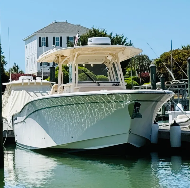 Slide: The Image of 2015 Grady-White 336 Canyon boat docked in a marina, sunny day. - 3