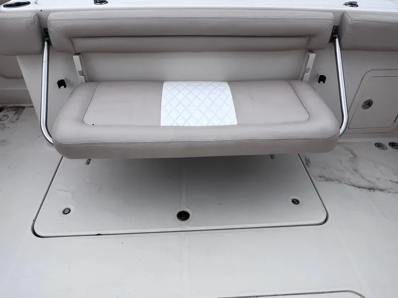 Slide: The Image of 2015 Grady-White 336 Canyon boat with foldable cushioned seat and storage compartment. - 30