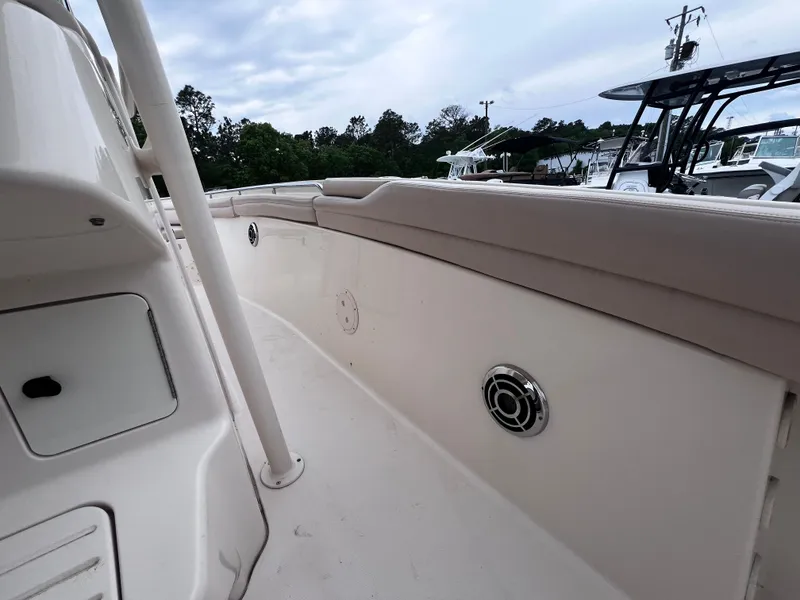 Slide: The Image of 2015 Grady-White 336 Canyon boat interior with beige seating and speaker detail. - 31