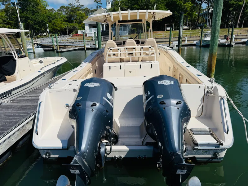 Slide: The Image of 2015 Grady-White 336 Canyon boat with twin Yamaha engines docked at marina. - 5