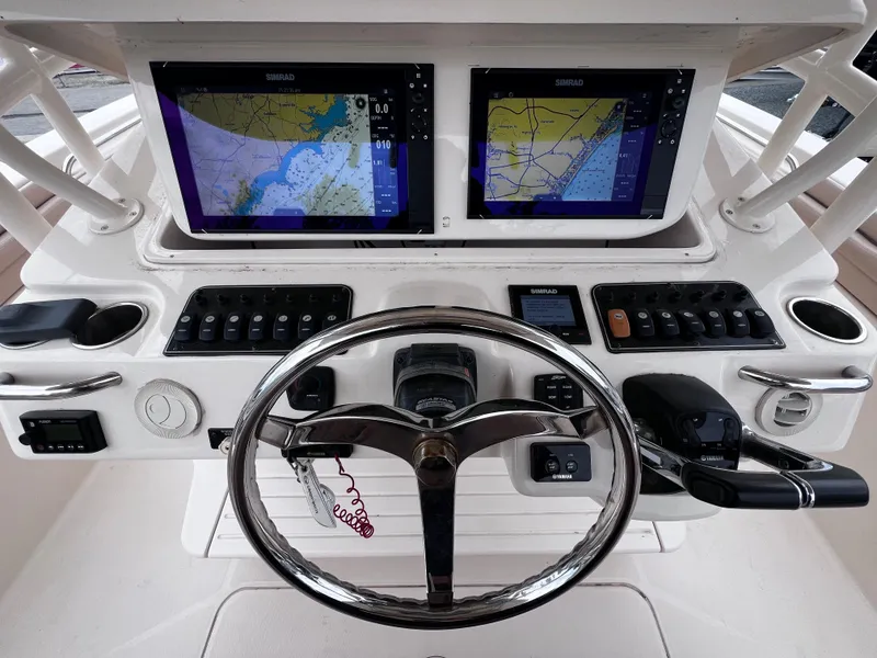 Slide: The Image of Control panel of 2015 Grady-White 336 Canyon boat with dual navigation screens. - 8