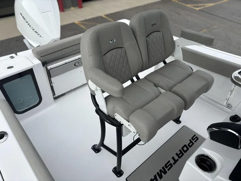 Slide: The Image of 2025 Sportsman Open 232 boat with dual gray seats and Mercury engine. - 11