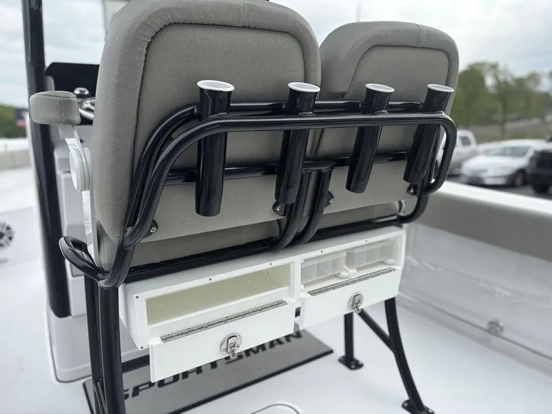Slide: The Image of 2025 Sportsman Open 232 boat seats with rod holders and storage compartments. - 15