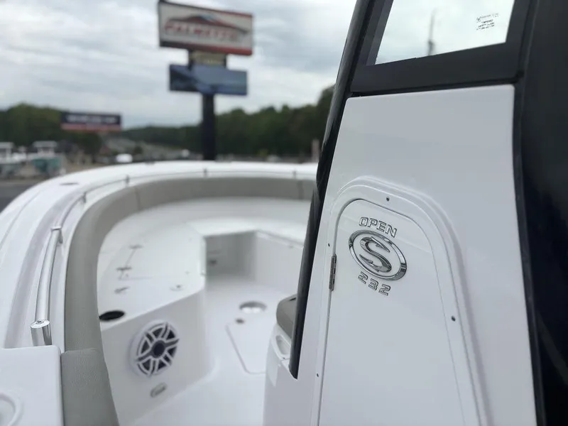 Slide: The Image of 2025 Sportsman Open 232 boat, sleek design, white interior, outdoor display. - 16