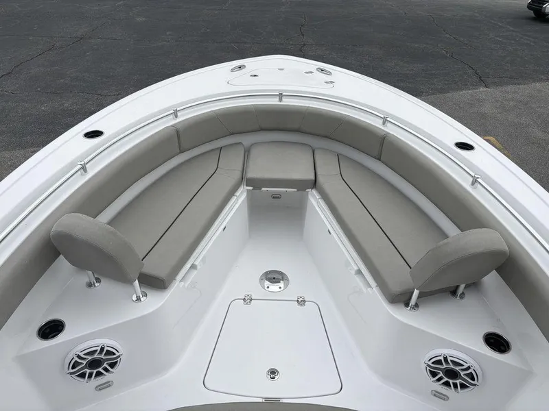 Slide: The Image of 2025 Sportsman Open 232 boat interior with cushioned seating and speakers. - 19