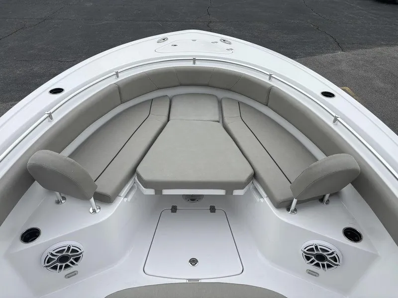 Slide: The Image of 2025 Sportsman Open 232 boat interior with cushioned seating and speakers. - 20