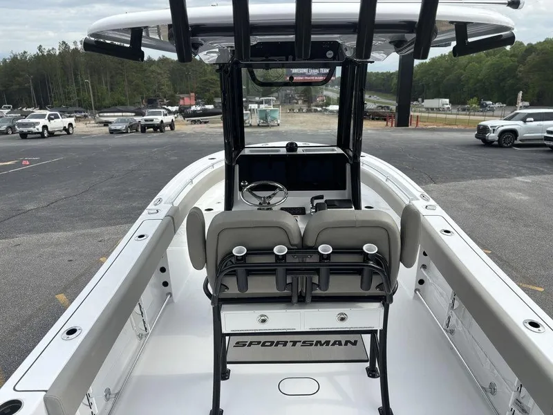Slide: The Image of 2025 Sportsman Open 232 boat interior with helm, parked in a lot. - 7