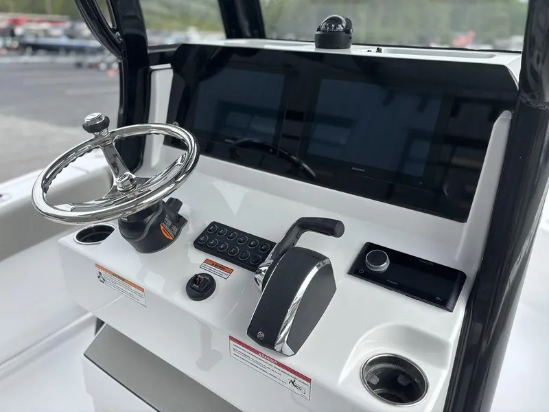 Slide: The Image of 2025 Sportsman Open 232 boat dashboard with steering wheel and control panel. - 9
