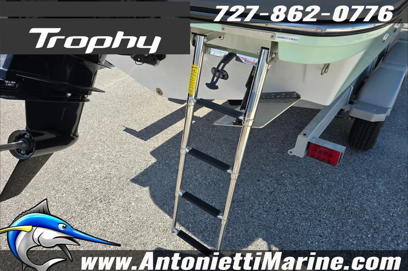 Slide: The Image of 2025 Trophy T22 SC boat on trailer, featuring rear ladder and marine logo. - 10