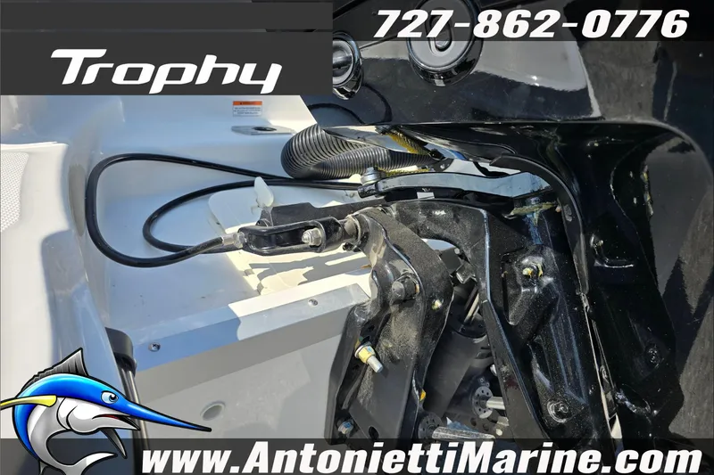 Slide: The Image of 2025 Trophy T22 SC boat interior with tan seating, steering wheel, and marine branding. - 39