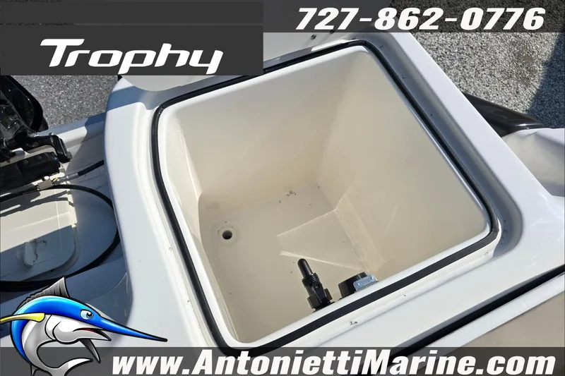 Slide: The Image of 2025 Trophy T22 SC boat interior with beige seating, steering wheel, and logo. - 48