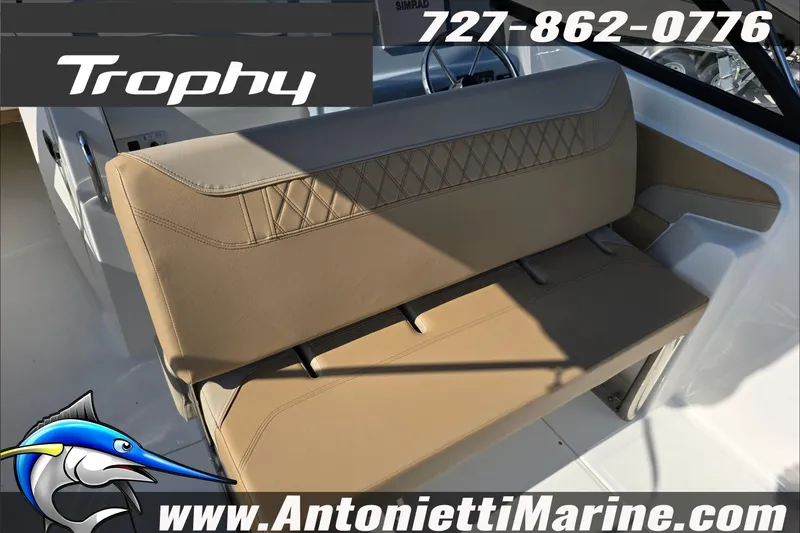 Slide: The Image of 2025 Trophy T22 SC boat interior with tan seating, cup holders, and branding details. - 60