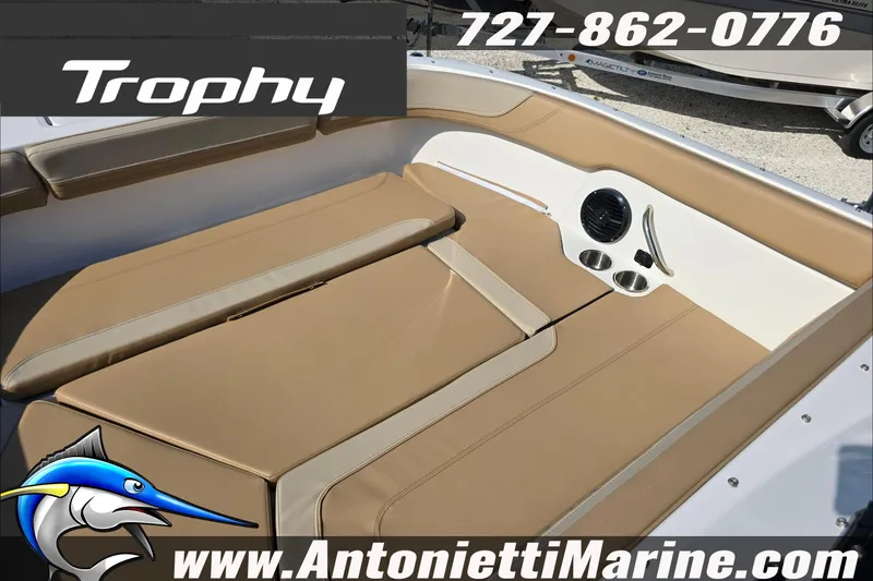 Slide: The Image of 2025 Trophy T22 SC boat interior with tan seating, contact info, and website. - 67