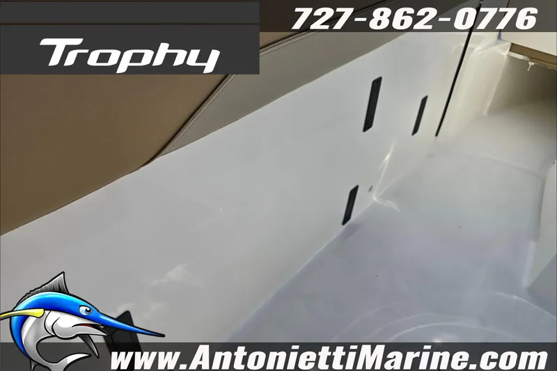 Slide: The Image of 2025 Trophy T22 SC boat on trailer at dealership, under clear sky. - 76