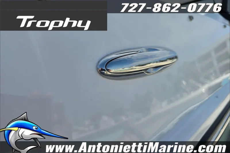 Slide: The Image of Interior view of 2025 Trophy T22 SC boat with beige seating and steering console. - 79