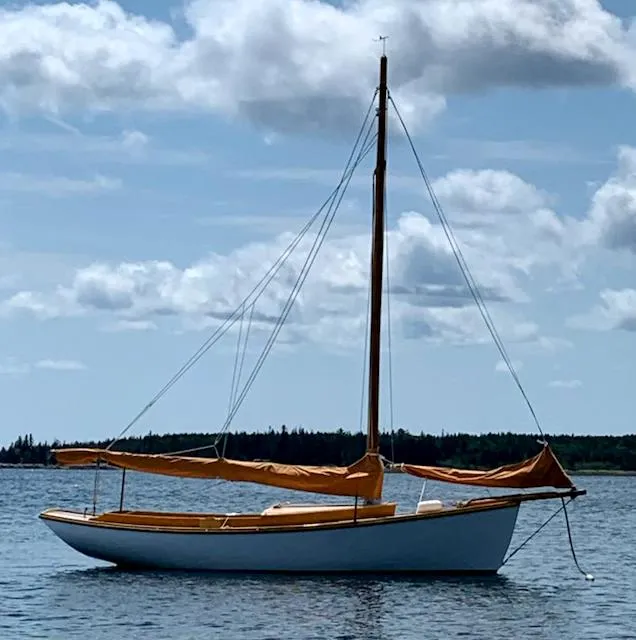The Image of Sailboat on calm water, Stanley 19 model, 1986, under a partly cloudy sky. - 1