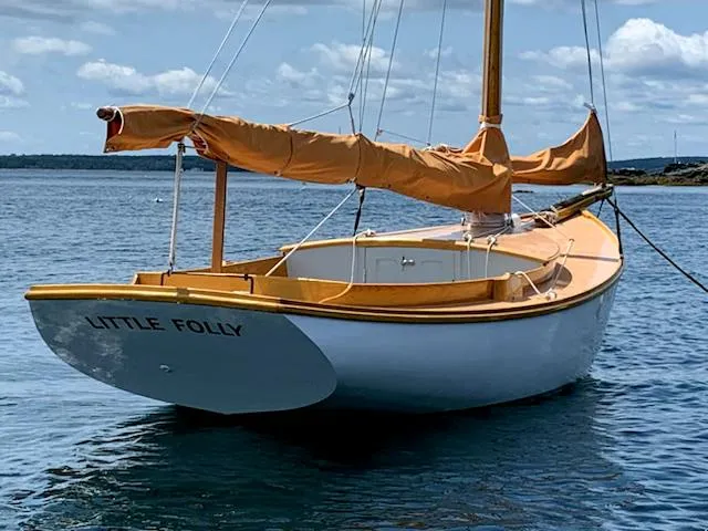 Slide: The Image of Classic 1986 Stanley 19 sailboat named "Little Folly" on calm water. - 2
