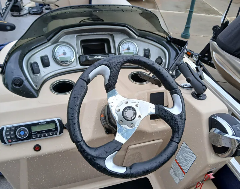 Slide: The Image of Steering console of a 2017 Sun Tracker FB 24XP3 boat with gauges and controls. - 3