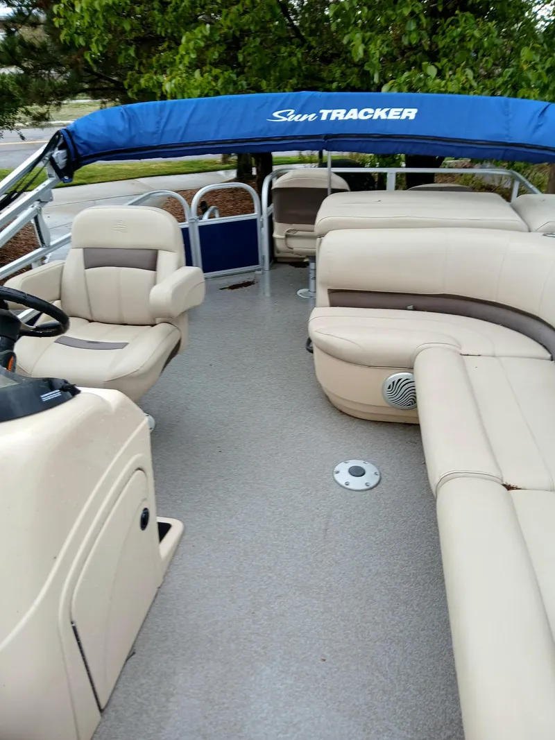 Slide: The Image of 2017 Sun Tracker FB 24XP3 pontoon boat with beige seating and blue canopy. - 4